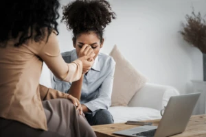 sad-ptsd-woman-patient-crucial-therapy-mental-health-with-psychologist-depression-grief-after-life-failure-frustrated-trauma-young-woman-talking-psychologist-about-emotion-clinic